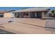 Single-story home featuring desert landscaping and a covered carport on a sunny day at 719 W Pampa Ave, Mesa, AZ 85210