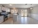 Well-lit kitchen with stainless steel appliances and a sliding glass door to the backyard at 719 W Pampa Ave, Mesa, AZ 85210