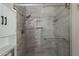 Close up of shower with glass door, gray tile surround and multiple shower heads at 719 W Pampa Ave, Mesa, AZ 85210