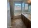 Bathroom featuring a large soaking tub, separate shower, and double sink vanity at 7327 W Donner Dr, Laveen, AZ 85339
