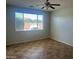 Sun-filled bedroom featuring a large window, neutral walls, and tile flooring at 7327 W Donner Dr, Laveen, AZ 85339