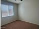 Bedroom featuring carpeted floors and a large window at 7327 W Donner Dr, Laveen, AZ 85339