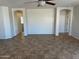 Spacious living room featuring neutral walls, tile flooring, and arched doorways at 7327 W Donner Dr, Laveen, AZ 85339