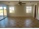 Bright living room with tile flooring, ceiling fan, and sliding glass door for natural light at 7327 W Donner Dr, Laveen, AZ 85339
