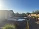 Backyard swimming pool with rock accents and mature desert landscaping at 7327 W Donner Dr, Laveen, AZ 85339