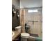 This bathroom includes a toilet, shower with tile surround, and a modern grab bar for accessibility at 8218 S 7Th St # Ofc, Phoenix, AZ 85042