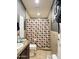 Neutral-toned bathroom featuring a toilet, sink with vanity, and a shower with a patterned curtain at 8218 S 7Th St # Ofc, Phoenix, AZ 85042