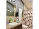 This bathroom includes a vanity with decorative tile, and a shower with patterned shower curtain at 8218 S 7Th St # Ofc, Phoenix, AZ 85042