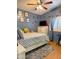 Bright bedroom with blue walls, playful decor, and plenty of natural light and a wood look floor at 8218 S 7Th St # Ofc, Phoenix, AZ 85042