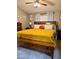 Comfortable bedroom with ceiling fan, gray walls, wood furniture and a yellow bedspread at 8218 S 7Th St # Ofc, Phoenix, AZ 85042