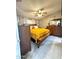 Cozy bedroom featuring a warm yellow bedspread, light gray plank floors, and neutral colored walls at 8218 S 7Th St # Ofc, Phoenix, AZ 85042