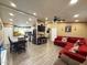 Inviting living room and kitchen area featuring a red couch, modern lighting, and open layout at 8218 S 7Th St # Ofc, Phoenix, AZ 85042