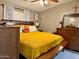 Comfortable main bedroom featuring a king bed, a dark dresser and light-colored walls at 8218 S 7Th St # Ofc, Phoenix, AZ 85042