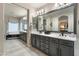 Bathroom featuring a double vanity and soaking tub in a well-lit, neutral-toned setting at 8447 W Tether Trl, Peoria, AZ 85383