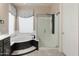 Bathroom featuring a glass-enclosed shower, a garden tub, and modern fixtures at 8447 W Tether Trl, Peoria, AZ 85383