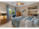 Serene bedroom features built-in shelving, a window view, and a calm color scheme at 8447 W Tether Trl, Peoria, AZ 85383
