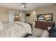 Well-lit bedroom featuring a cozy bed, a large dresser, and access to the upstairs hallway at 8447 W Tether Trl, Peoria, AZ 85383