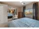 Cozy bedroom featuring a blue quilt, a window view and mirrored closet doors at 8447 W Tether Trl, Peoria, AZ 85383