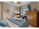 Comfortable bedroom featuring a ceiling fan, window with neighborhood views, and armoire at 8447 W Tether Trl, Peoria, AZ 85383