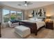 Bright bedroom with a large window offering mountain views, featuring a king bed at 8447 W Tether Trl, Peoria, AZ 85383