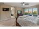 Comfortable bedroom with a large bed, a view to a bathroom, and outdoor scenery at 8447 W Tether Trl, Peoria, AZ 85383