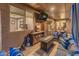 Relaxing covered patio with comfortable seating, a fire table, and views of the backyard at 8447 W Tether Trl, Peoria, AZ 85383