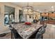 Elegant dining area with a modern chandelier and an open view of the kitchen at 8447 W Tether Trl, Peoria, AZ 85383