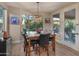 Bright dining area with a modern chandelier and views of the backyard pool at 8447 W Tether Trl, Peoria, AZ 85383