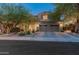 Charming two-story home with a well-manicured lawn, desert landscaping, and a three-car garage at 8447 W Tether Trl, Peoria, AZ 85383