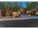Beautiful two-story home featuring desert landscaping, a manicured lawn, and a three-car garage at 8447 W Tether Trl, Peoria, AZ 85383