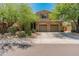 Charming two-story home showcasing a well-manicured lawn and a spacious three-car garage at 8447 W Tether Trl, Peoria, AZ 85383