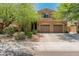 Charming two-story home showcasing a well-manicured lawn and a spacious three-car garage at 8447 W Tether Trl, Peoria, AZ 85383