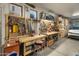 Spacious garage featuring well-lit workbenches, pegboards, and ample storage at 8447 W Tether Trl, Peoria, AZ 85383