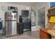 Organized garage space with extra fridge, storage, and workbench at 8447 W Tether Trl, Peoria, AZ 85383