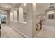 Spacious hallway featuring arched niches and neutral tones leading to a staircase at 8447 W Tether Trl, Peoria, AZ 85383