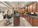 Spacious kitchen with wooden cabinets, stainless steel appliances, and a functional island at 8447 W Tether Trl, Peoria, AZ 85383