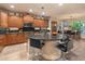Gourmet kitchen features a center island with seating, dark granite countertops, and rich wood cabinetry at 8447 W Tether Trl, Peoria, AZ 85383