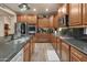 Well-equipped kitchen with dark countertops, stainless steel appliances, and ample cabinet space at 8447 W Tether Trl, Peoria, AZ 85383