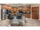 Modern kitchen with stainless steel appliances, center island with seating and dark countertops at 8447 W Tether Trl, Peoria, AZ 85383