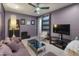 The Gathering room features a plum colored wall, decorative ceiling fan, and a sliding barn door at 8447 W Tether Trl, Peoria, AZ 85383