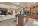 Open floor plan showcasing the kitchen island, living room fireplace and hardwood floors at 8447 W Tether Trl, Peoria, AZ 85383