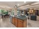 Open layout features a kitchen island, dining area, and views of the backyard at 8447 W Tether Trl, Peoria, AZ 85383