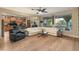 Bright and open floorplan includes living room with white L-shaped sofa, clerestory windows, and view into the kitchen at 8447 W Tether Trl, Peoria, AZ 85383
