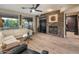 Cozy living room featuring stone accent wall with fireplace, large windows, and comfortable seating at 8447 W Tether Trl, Peoria, AZ 85383