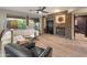 Bright living area showcases a stone accent wall with a fireplace, large windows, and comfortable seating with an open floorplan at 8447 W Tether Trl, Peoria, AZ 85383