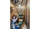 Walk-in pantry with storage shelving, food, cleaning, and household supplies, and a brick wall at 8447 W Tether Trl, Peoria, AZ 85383