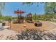 Community playground with modern play structures and natural landscaping for outdoor fun at 8447 W Tether Trl, Peoria, AZ 85383
