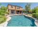 Inviting backyard oasis with a sparkling pool, cozy seating areas, and lush greenery creating a serene outdoor experience at 8447 W Tether Trl, Peoria, AZ 85383