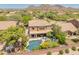 Stunning aerial view of the backyard featuring a private pool, covered patio, and lush landscaping at 8447 W Tether Trl, Peoria, AZ 85383
