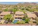 Stunning aerial view of the backyard featuring a private pool, covered patio, and lush landscaping at 8447 W Tether Trl, Peoria, AZ 85383
